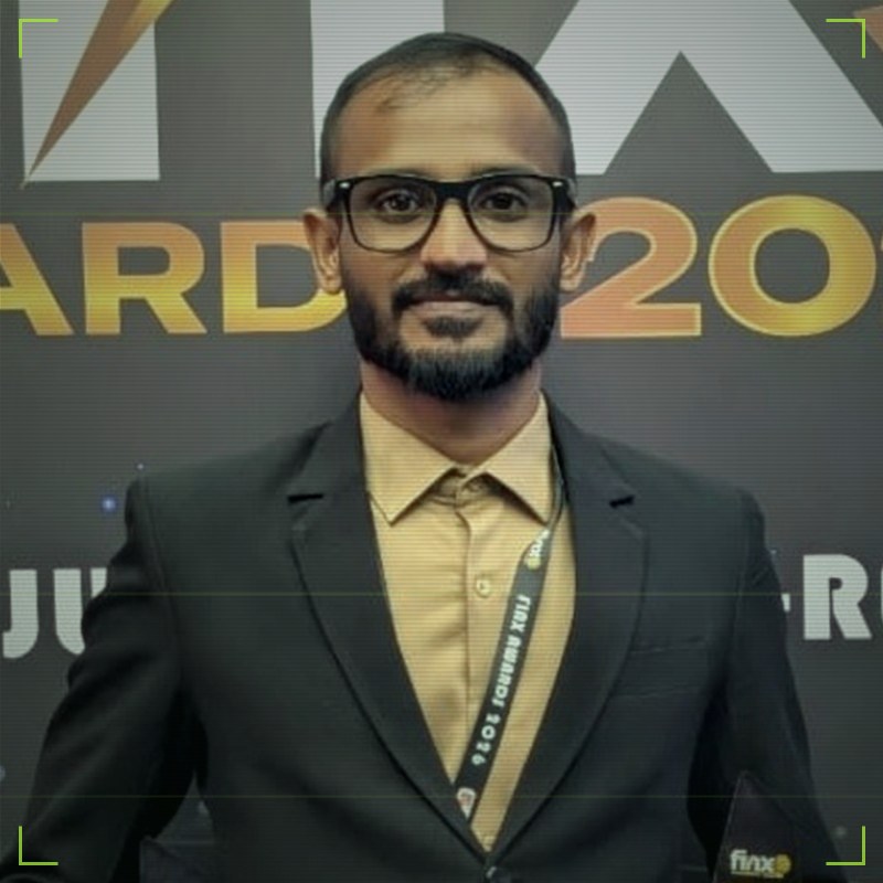 Mizhar Raja holding two FinX Awards 2026 trophies